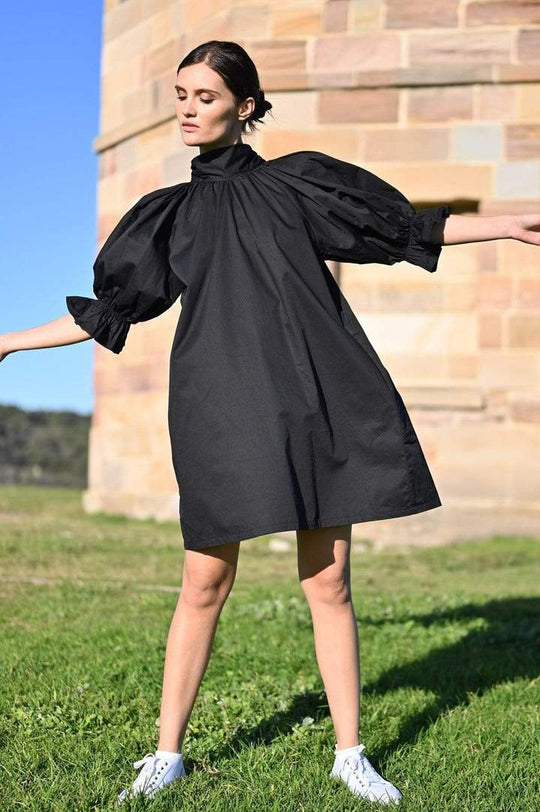 Adrian Reversible Dress - Black
The Adrian is Restocked - don't miss out on this fabulous dress We are excited about the Adrian - an oversized mini dress with on-trend puff sleeves, high neck and nape ties. The Adrian dress can also be worn back to front so you have a v- neckline and use the ties to to create a low knot or a bow at the front. So versatile, and such a statement piece! In the cooler months, team with tights and boots or wear over jeans. Designed for an oversized fit High Neck Nape Ties Side p