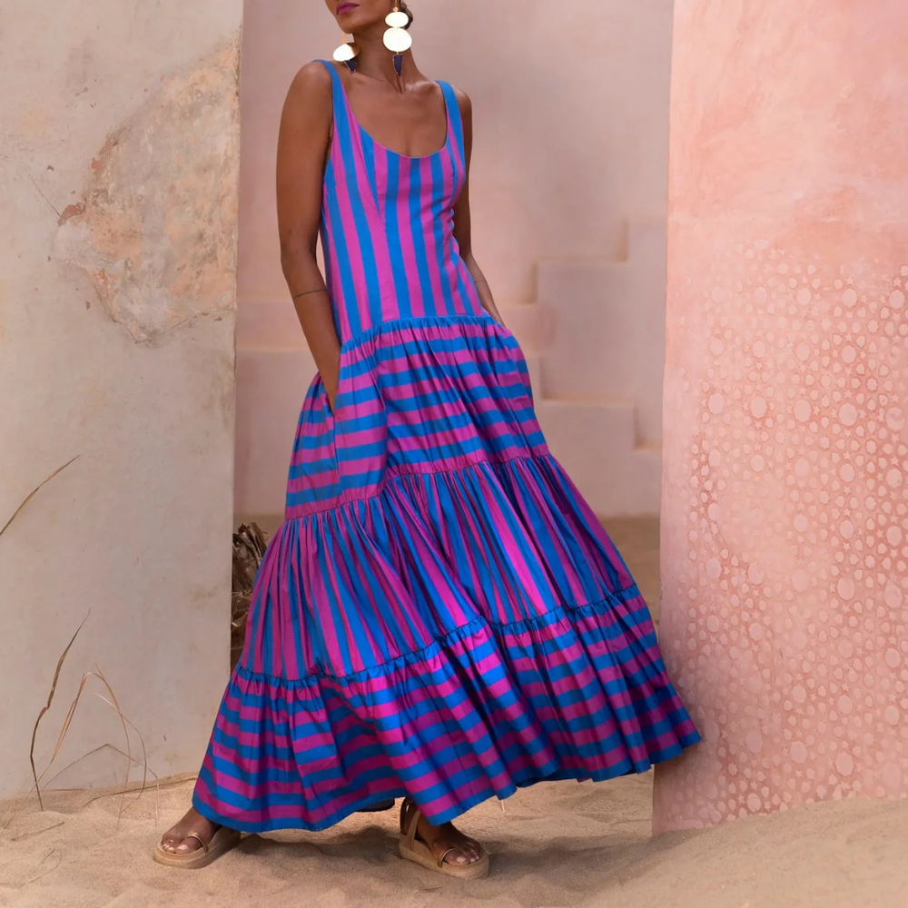Model wearing fuchsia and indigo striped maxi dress with scoop neck and tiered skirt – Erika Peña Selena Dress