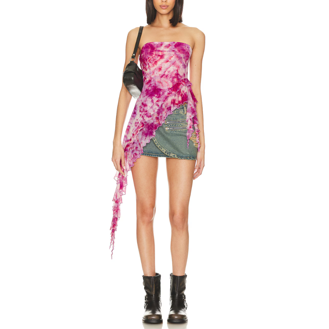 A woman wearing a lavender combo tube top with asymmetric draped ruffle sides and a tiered hem, paired with blue denim shorts.