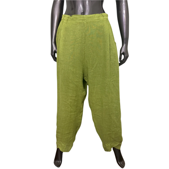 Green baggy pants on a mannequin against a white background
