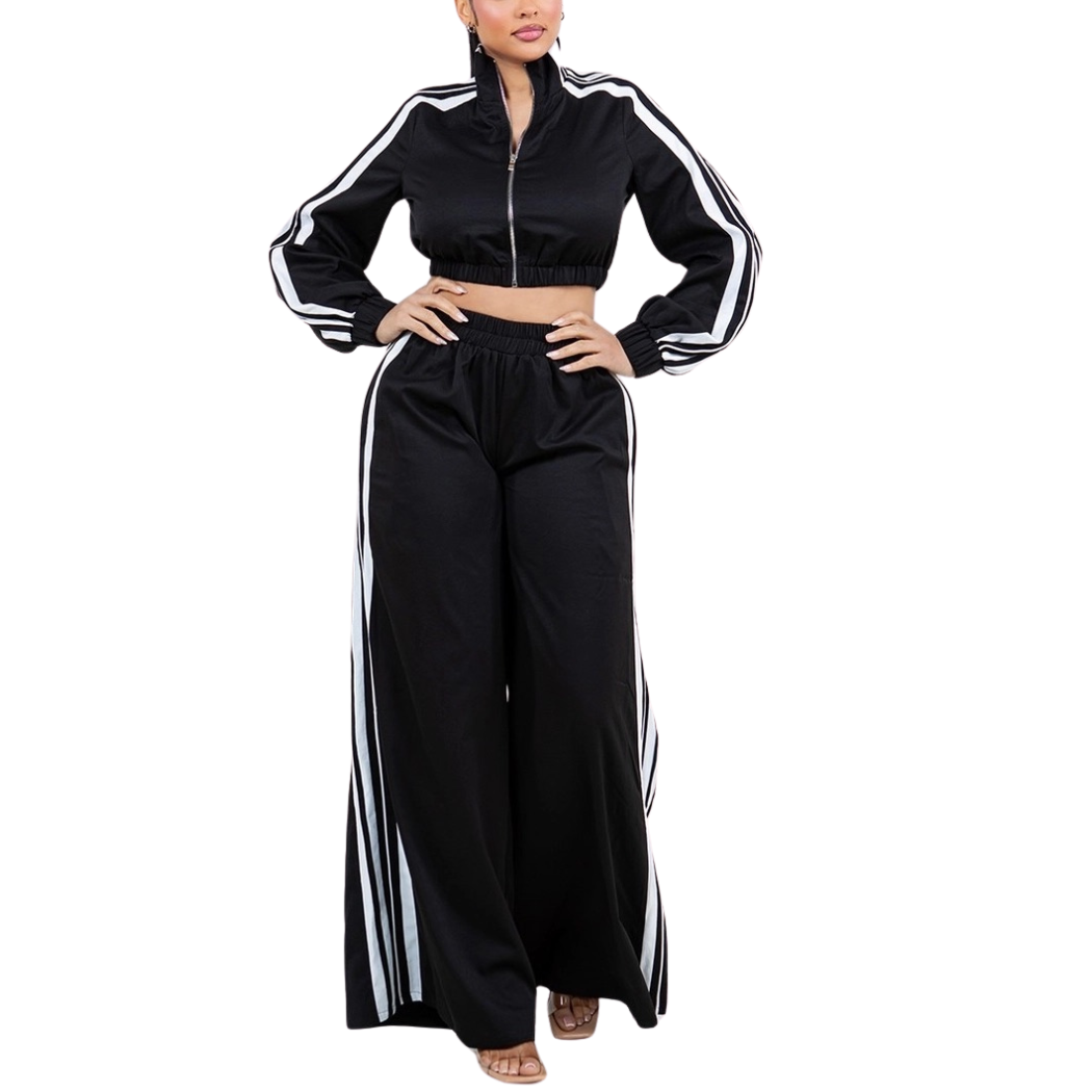 Black tracksuit with white stripes worn by a model on a white background