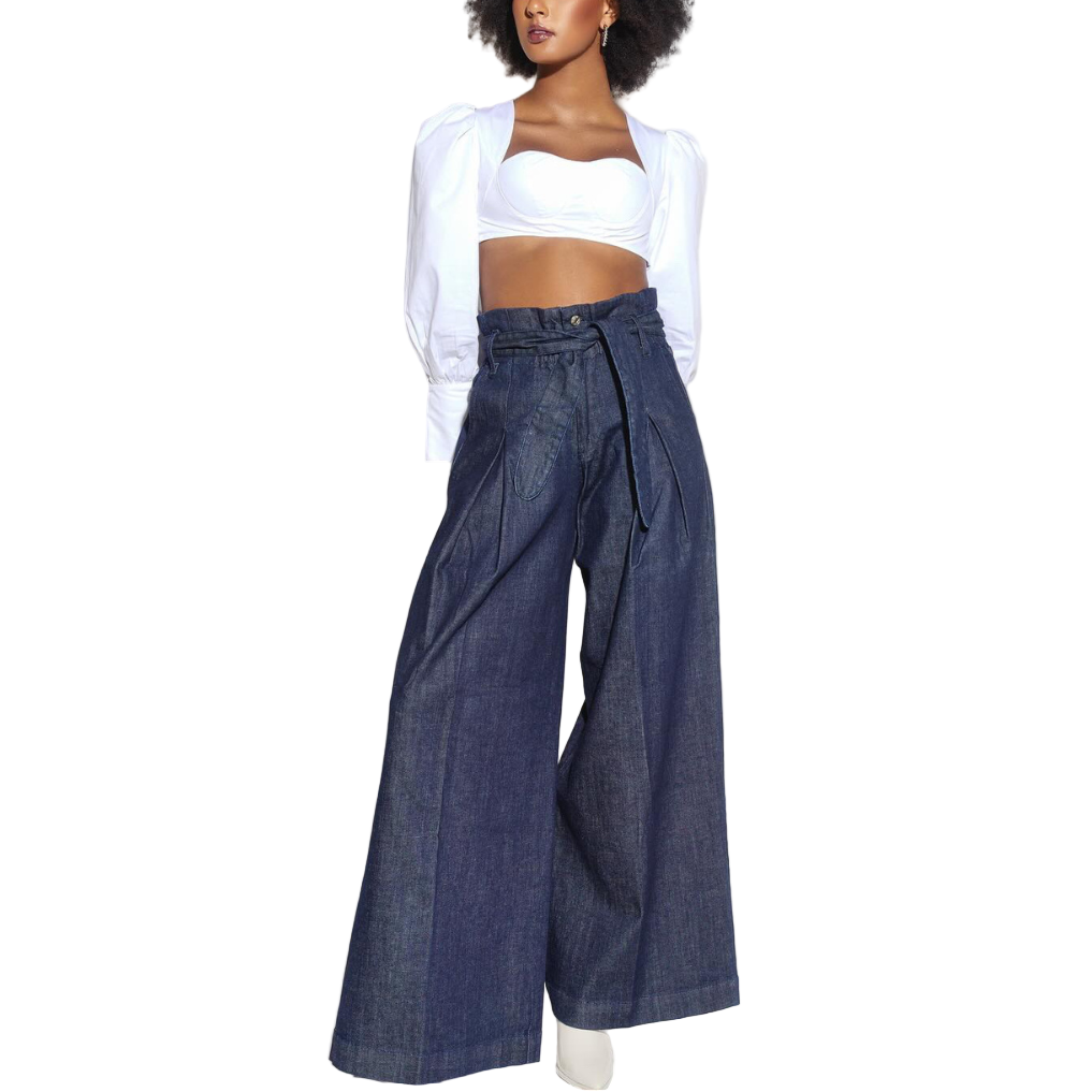 Woman wearing a white top and blue wide-leg jeans on a white background