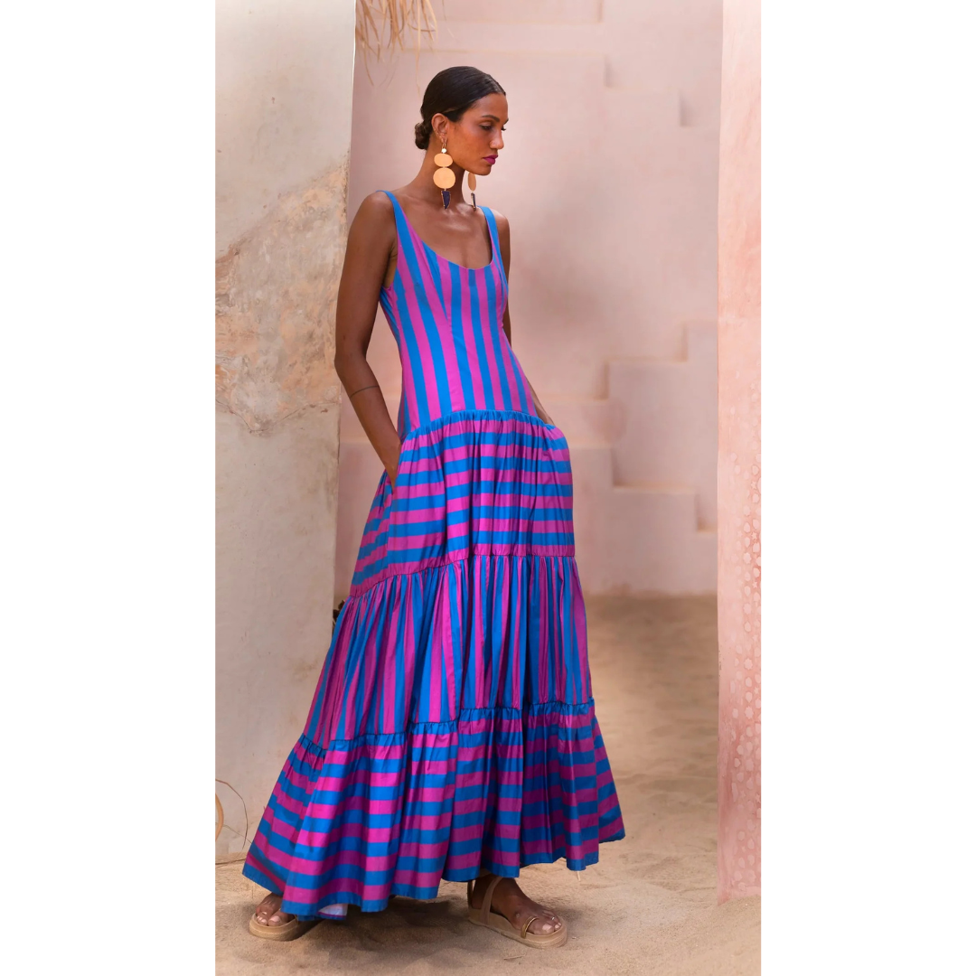Model wearing fuchsia and indigo striped maxi dress with scoop neck and tiered skirt – Erika Peña Selena Dress