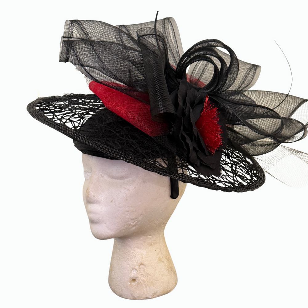 Black fascinator with red sculpted trim, tulle swirls, and floral rosette detail – handmade by Le’ Diva