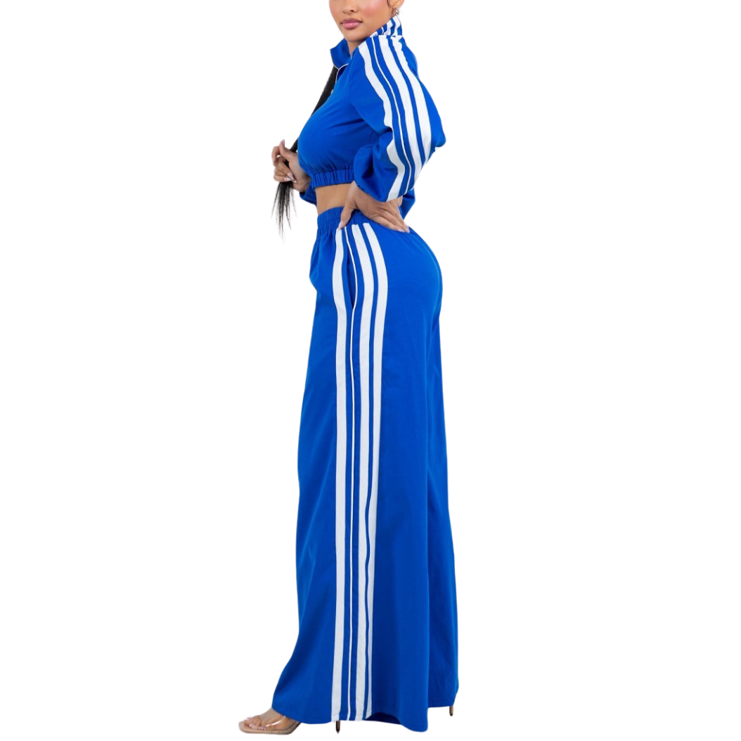 Woman wearing a blue outfit with white stripes on a white background