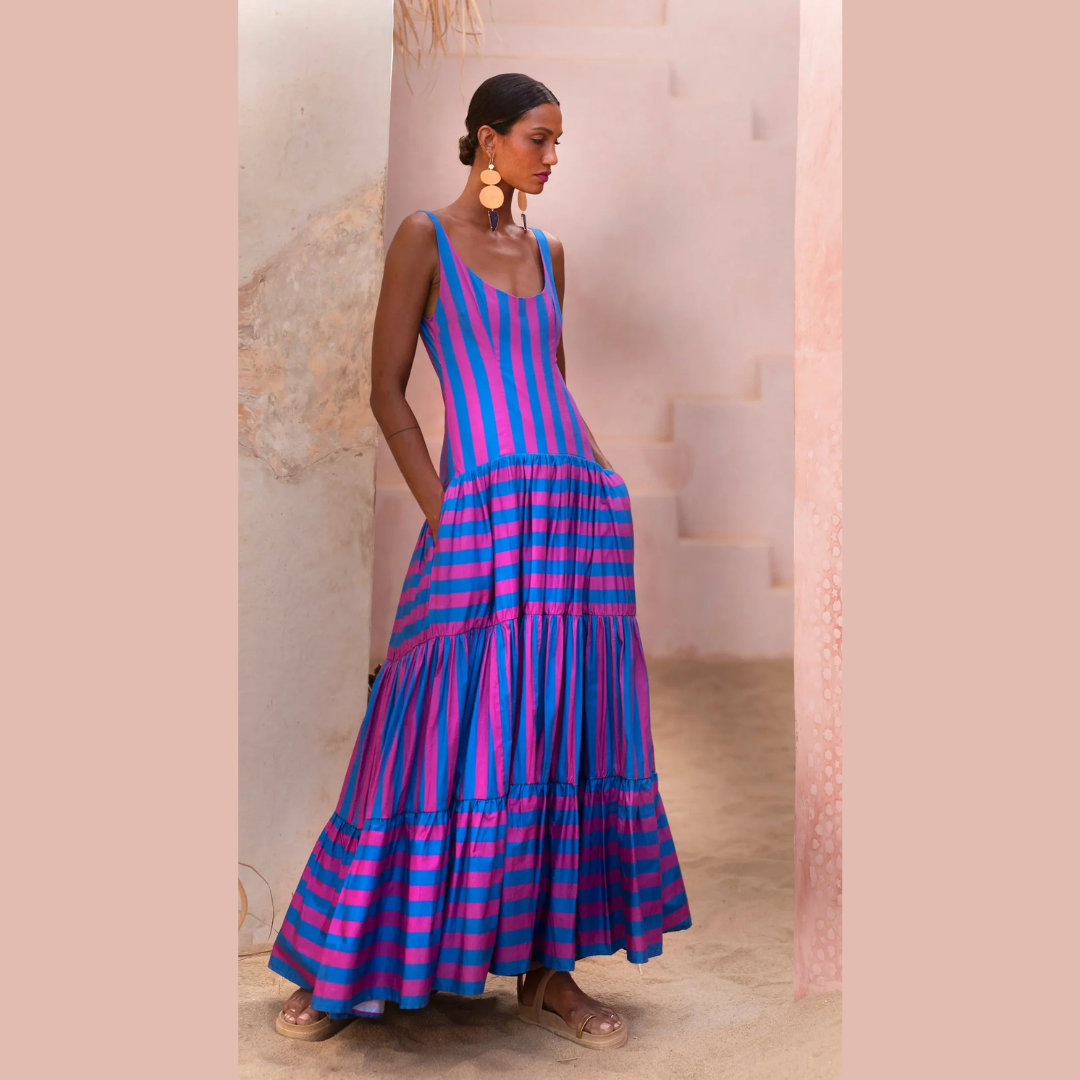 Model wearing fuchsia and indigo striped maxi dress with scoop neck and tiered skirt – Erika Peña Selena Dress