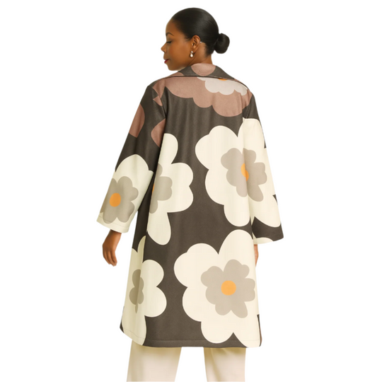 Woman wearing a floral patterned coat on a white background
