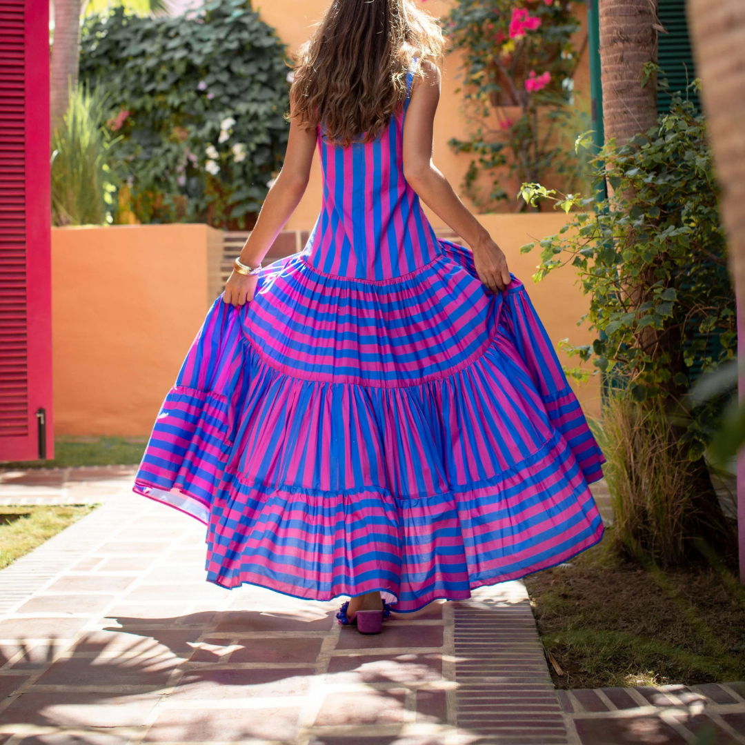Model wearing fuchsia and indigo striped maxi dress with scoop neck and tiered skirt – Erika Peña Selena Dress