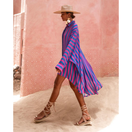Model wearing oversized striped shirt in fuchsia and indigo with long hem and button front – Erika Peña