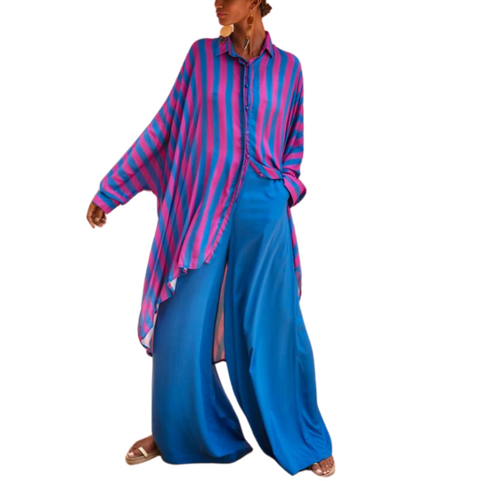 Model wearing oversized striped shirt in fuchsia and indigo with long hem and button front – Erika Peña