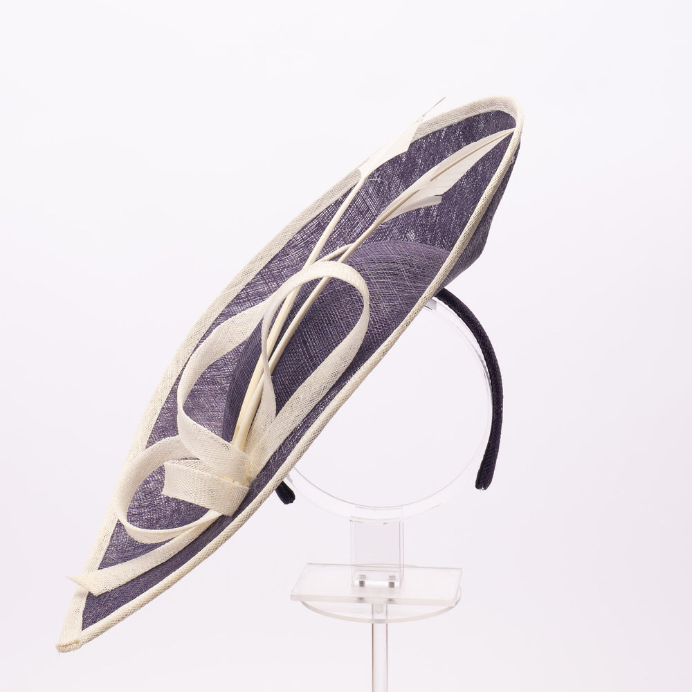 Large decorative hat with purple and white design on a white background