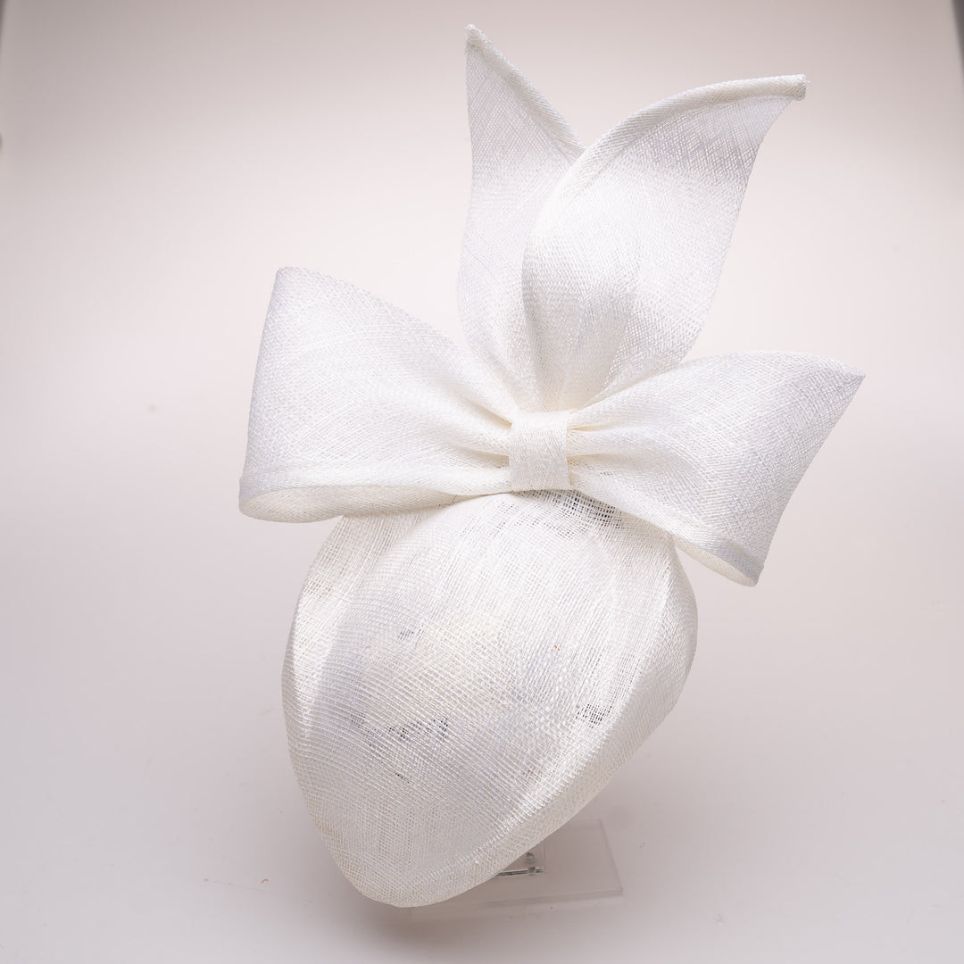 White decorative headband with a large bow on a light gray background