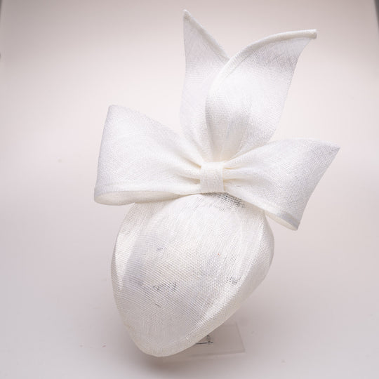 White decorative headband with a large bow on a light gray background