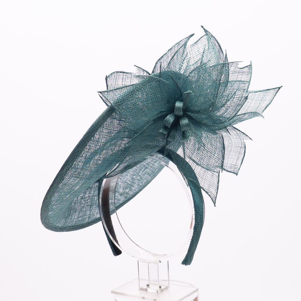 Teal mesh fascinator on a white background
