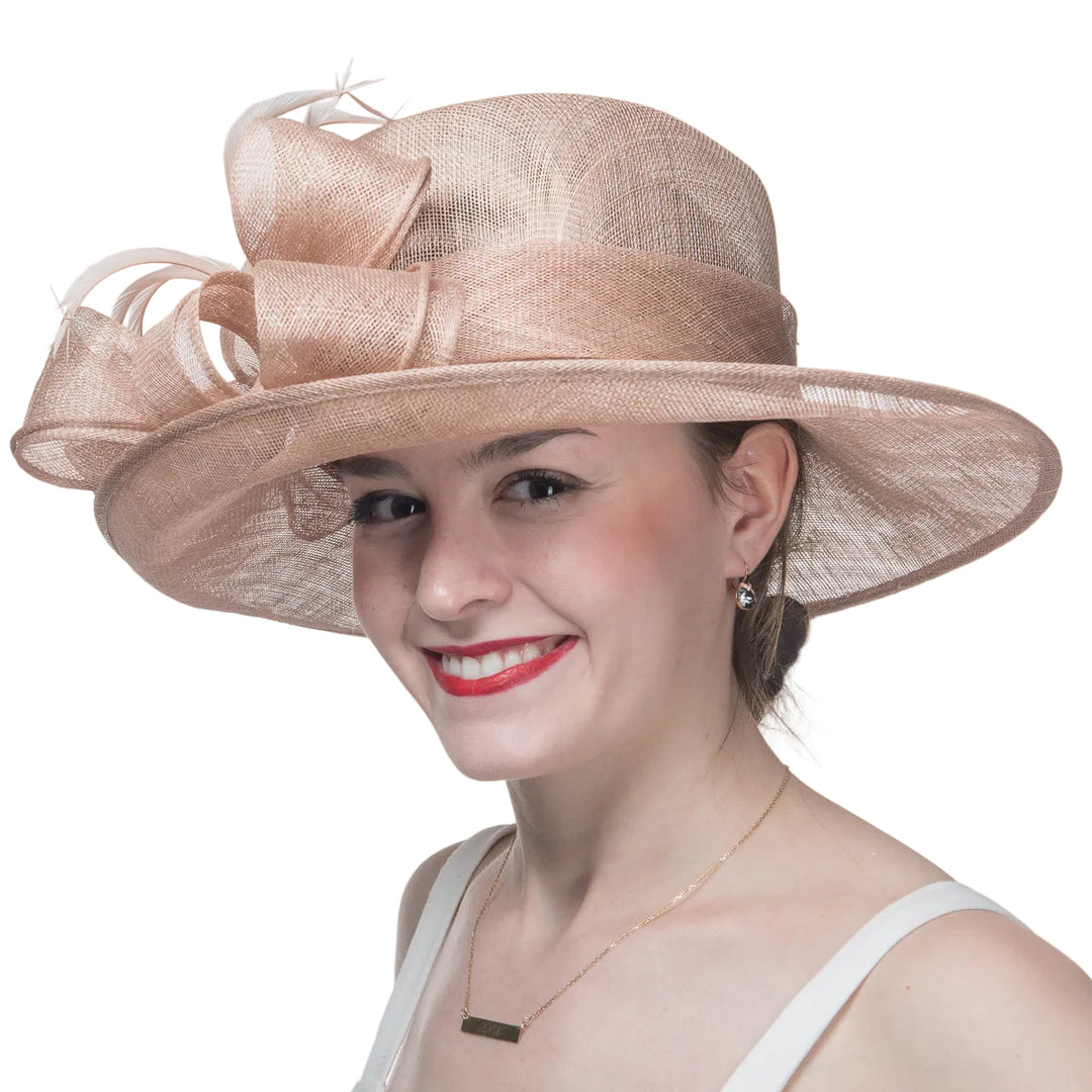 Woman wearing a beige hat with a large bow on a white background