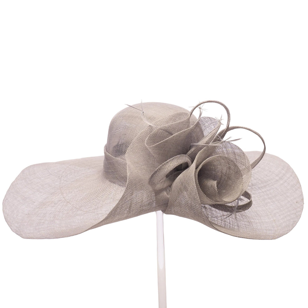 A light gray wide-brimmed fascinator hat made of textured woven material, displayed on a clear stand against a plain white background.