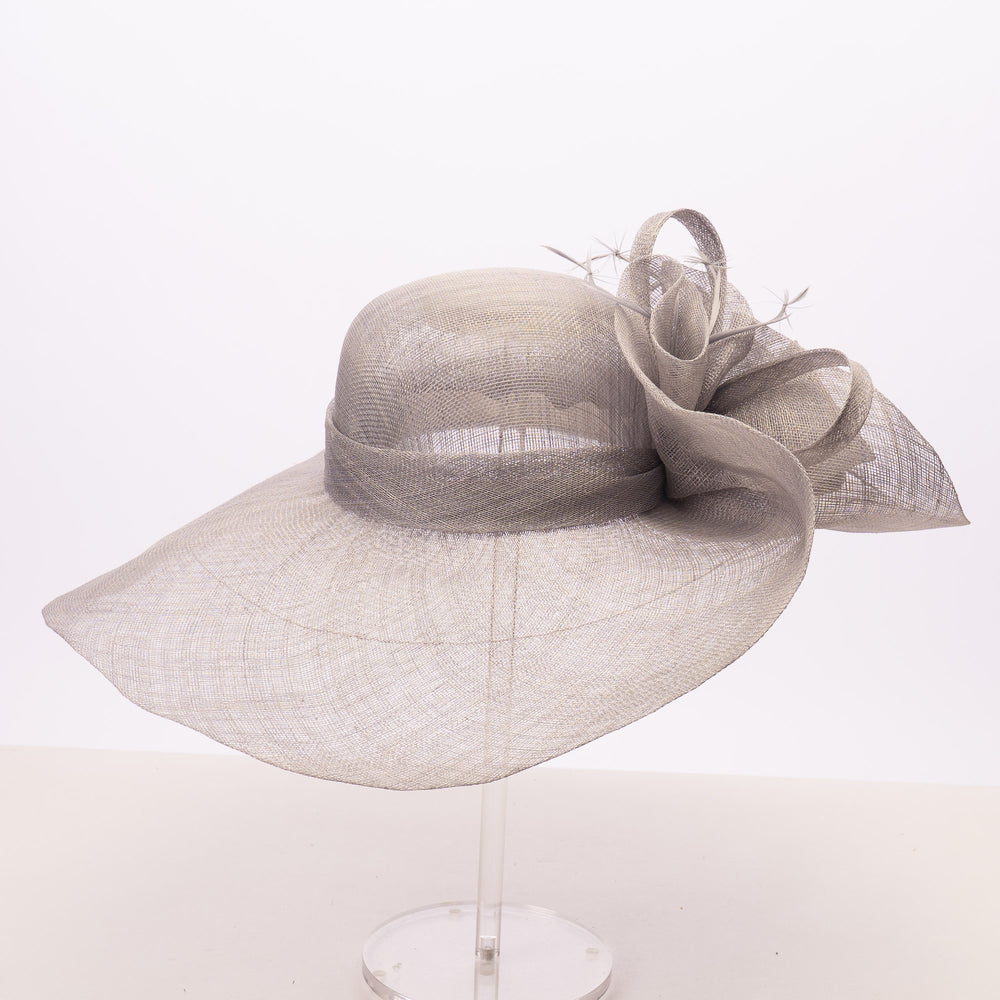 A light gray wide-brimmed fascinator hat made of sheer mesh fabric, displayed on a clear stand against a plain white background.