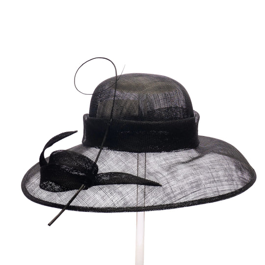 Black wide-brimmed hat with decorative bow on a white background