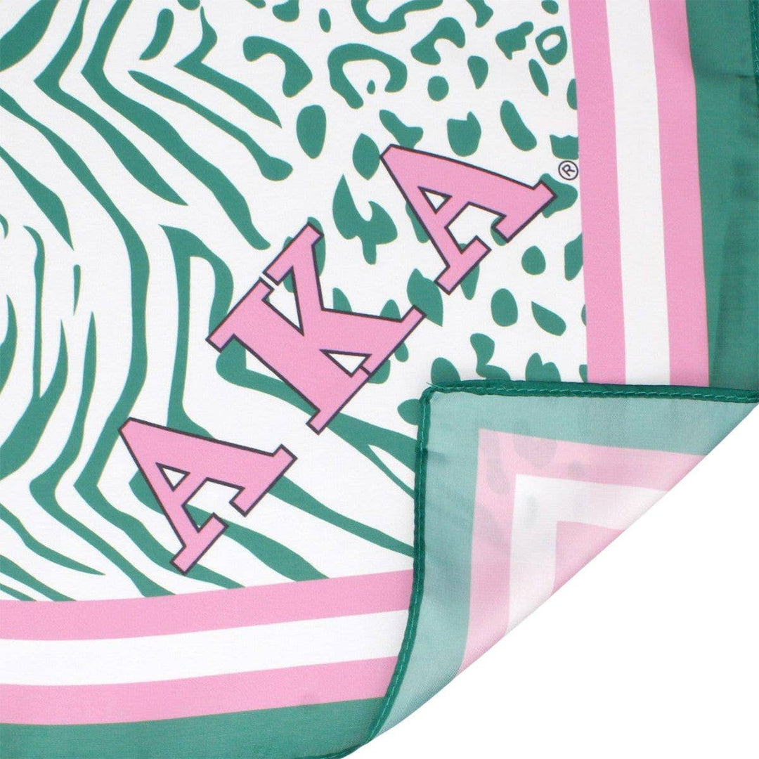 AKA Sorority scarf in green, white, and pink animal print with stripe edging, letters, and shield corners.