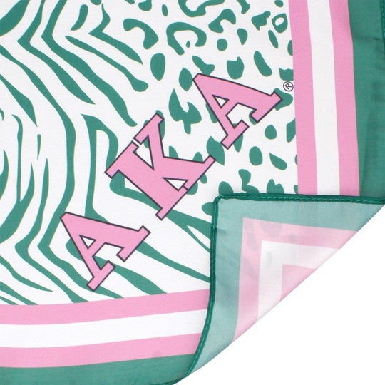 AKA Sorority scarf in green, white, and pink animal print with stripe edging, letters, and shield corners.