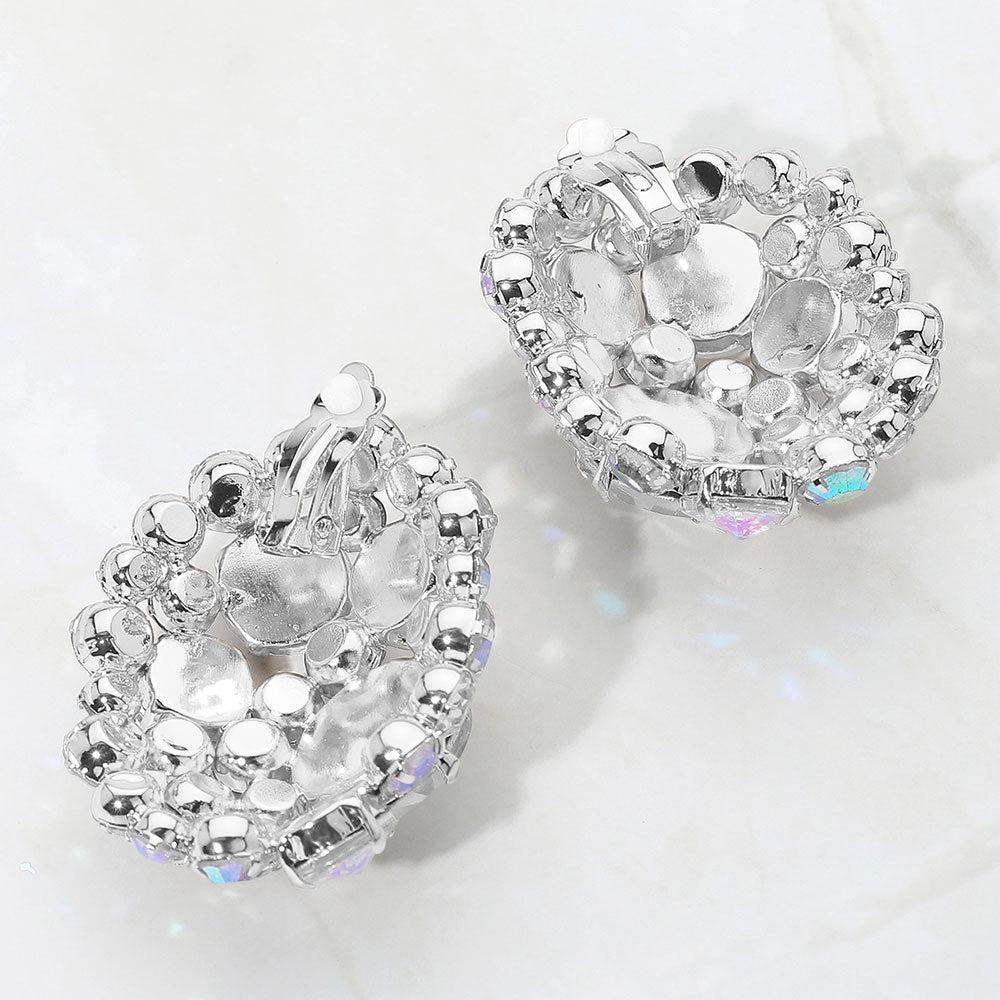 Silver heart-shaped earrings with clear gemstones on a white background