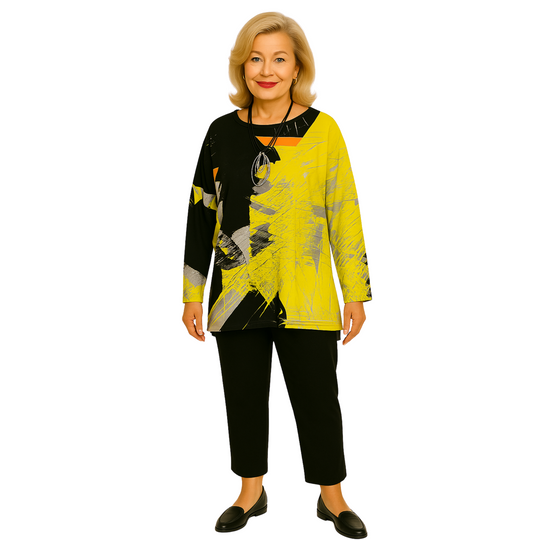 Woman wearing a yellow and black abstract patterned top with black pants on a white background