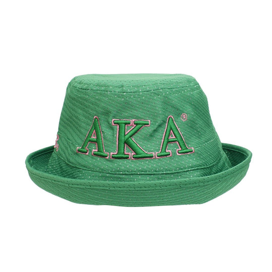Green straw hat with 'AKA' embroidery on a white background