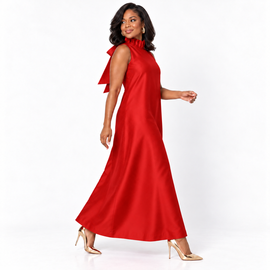 A woman modeling a sleeveless red maxi dress with a high ruffled neckline and a flowing skirt, paired with nude high heels, against a plain white studio background.