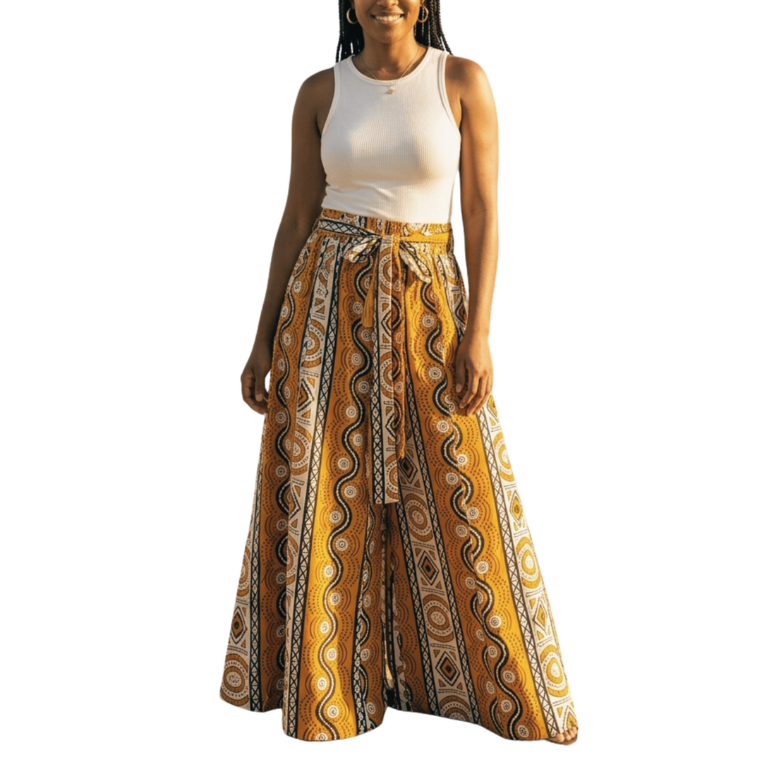 Woman wearing a white top and yellow patterned pants on a white background