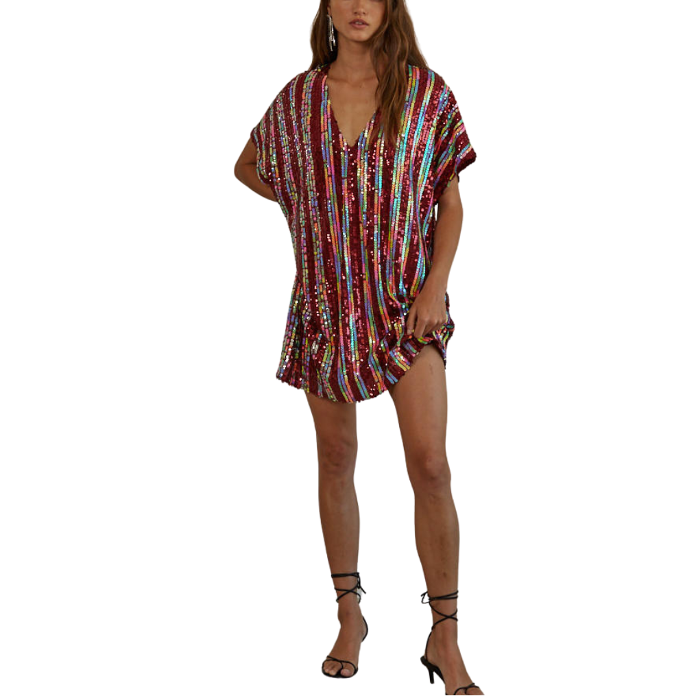 Woman wearing a colorful striped dress on a white background