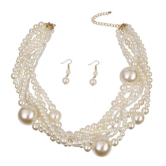 Pearl necklace and earrings set on a white background
