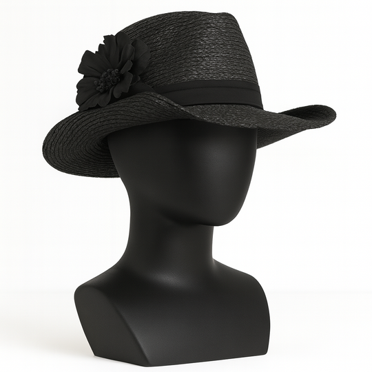 Black straw hat with a flower on a black mannequin head against a white background