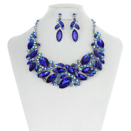 A mannequin showcasing a royal blue marquise rhinestone leaf cluster necklace and matching earrings.