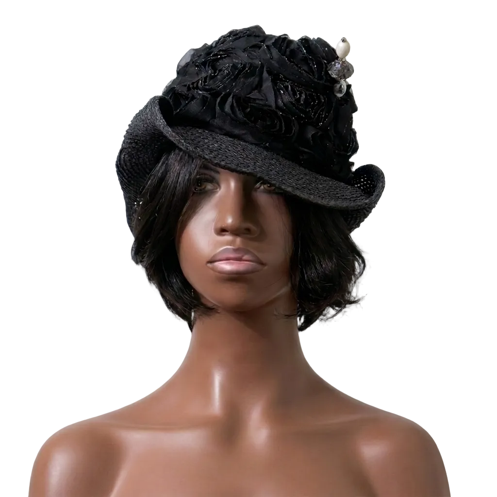 Mannequin head wearing a black floral hat against a plain background