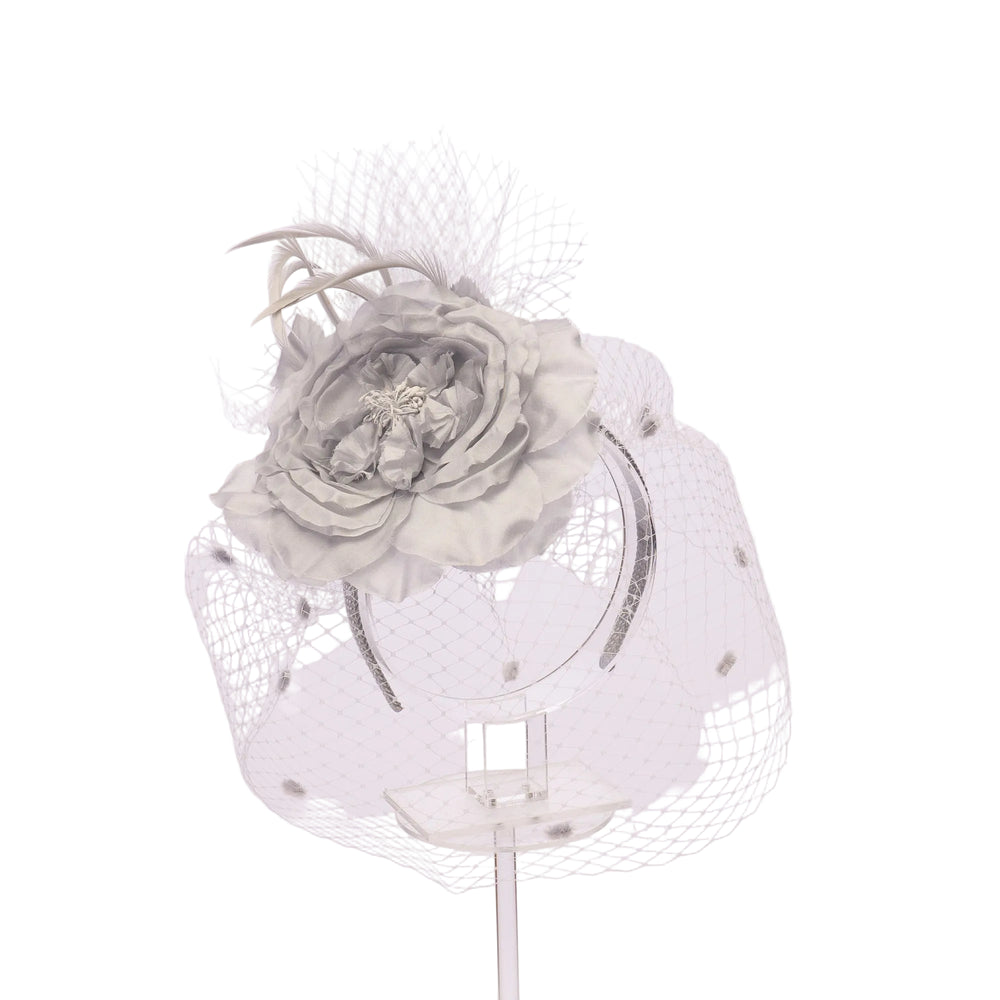Decorative headband with a large gray flower on a light pink background