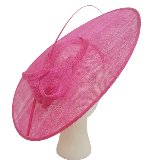 Pink decorative hat on a mannequin head against a white background