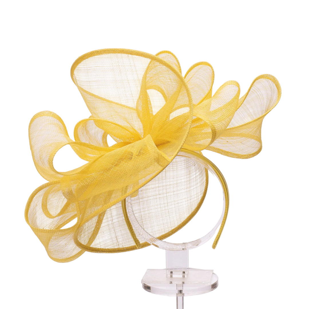 Yellow decorative headband on a mannequin head against a white background