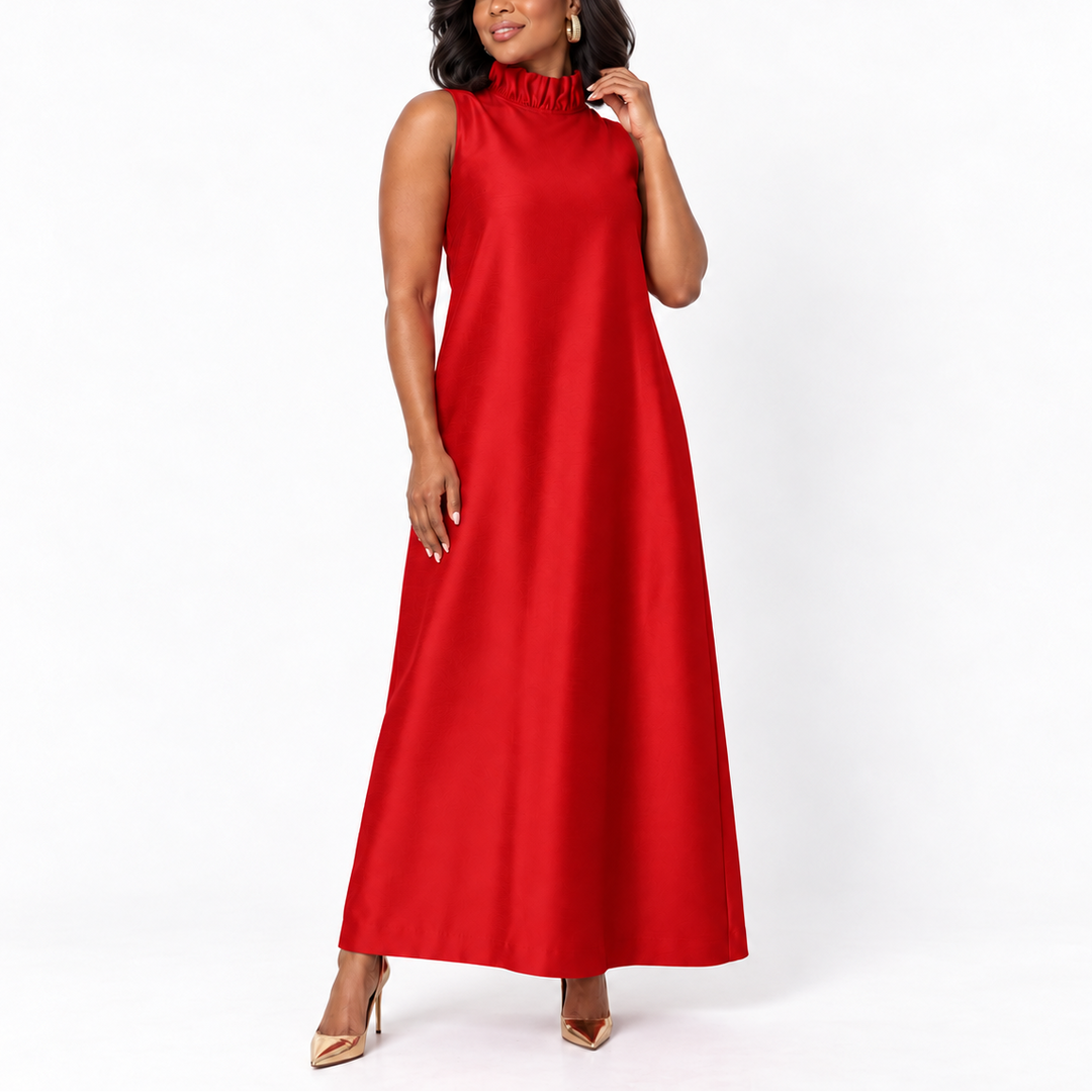 A woman modeling a sleeveless red maxi dress with a ruffled high neckline, photographed against a clean white studio background.