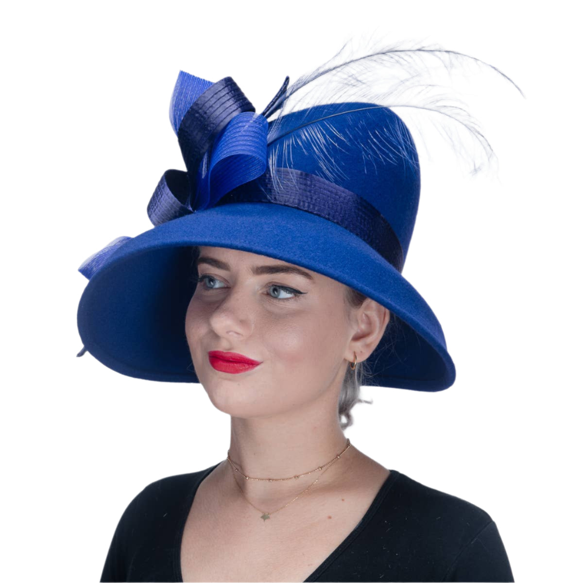 Woman wearing a blue hat with a large bow and feather on a white background