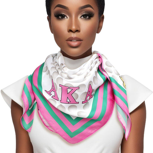 AKA Sorority scarf in pink, green, white, and grey polka dot pearl-like print with stripe edging, letters, and shield corners.