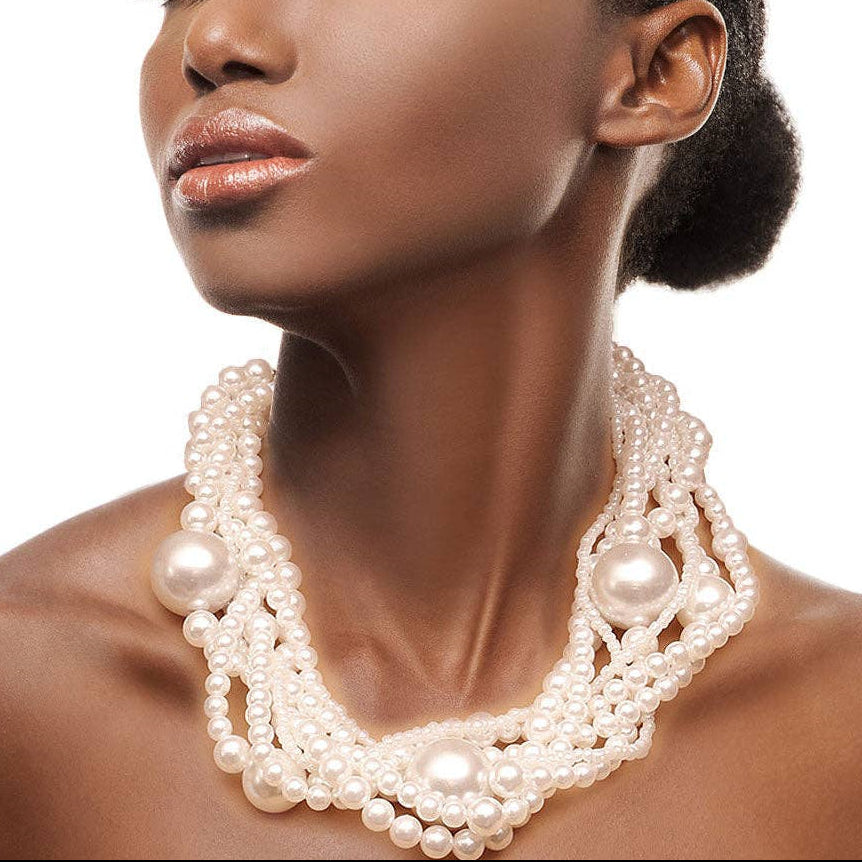 Woman wearing a pearl necklace against a white background