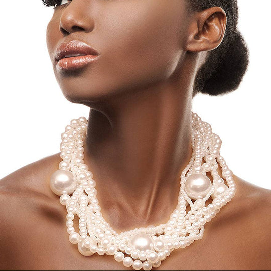 Woman wearing a pearl necklace against a white background