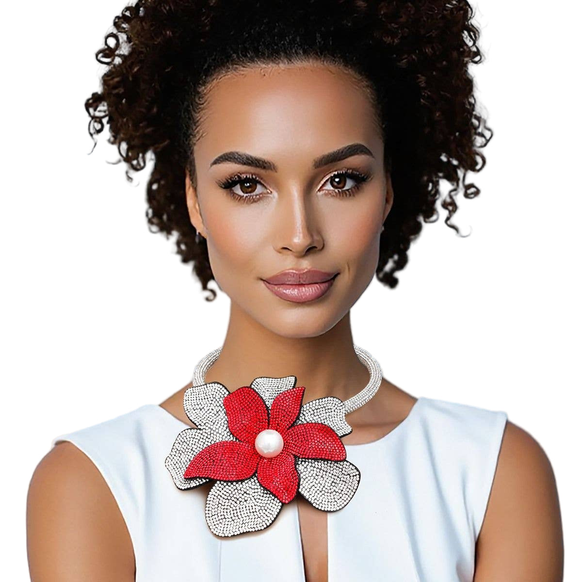 Woman wearing a white top with a red floral accessory on a white background