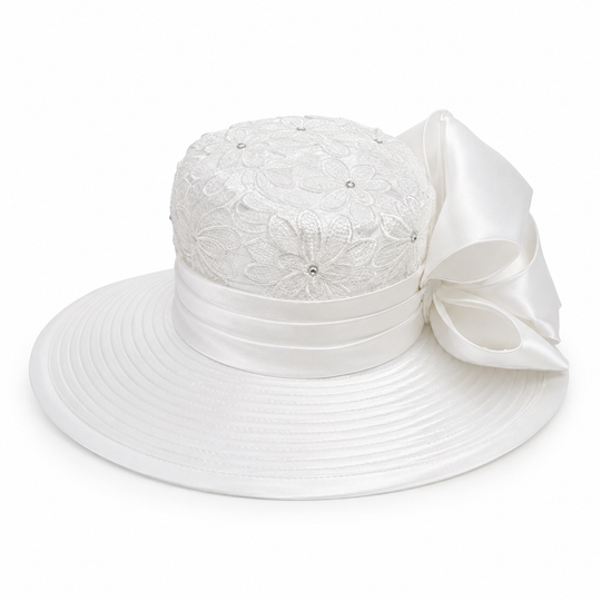 White wide-brimmed sun hat featuring a textured lace crown, a satin ribbon band, and a large decorative bow on the side, shown against a plain white background.