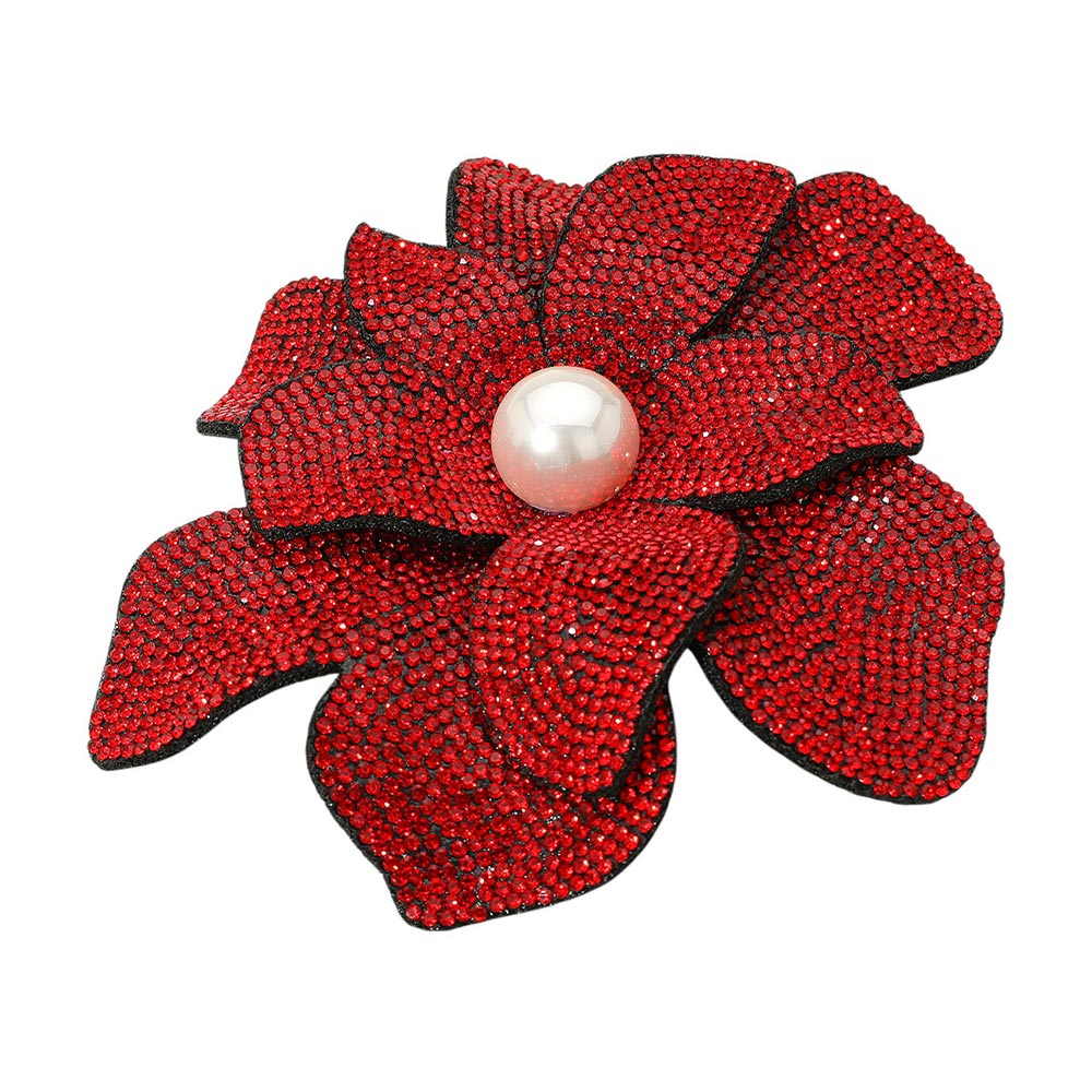 Red flower-shaped brooch with a pearl center on a white background