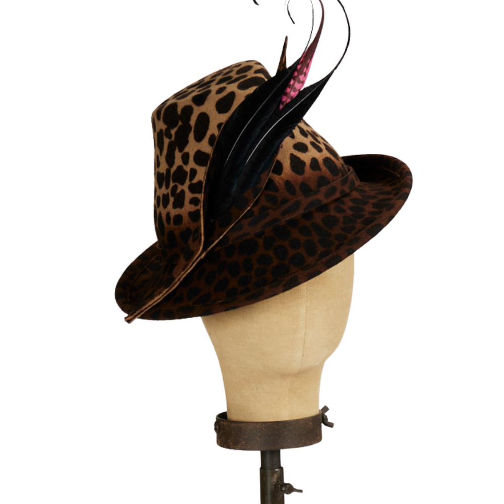 Front view of leopard-print fedora with feathers styled on model in beige top