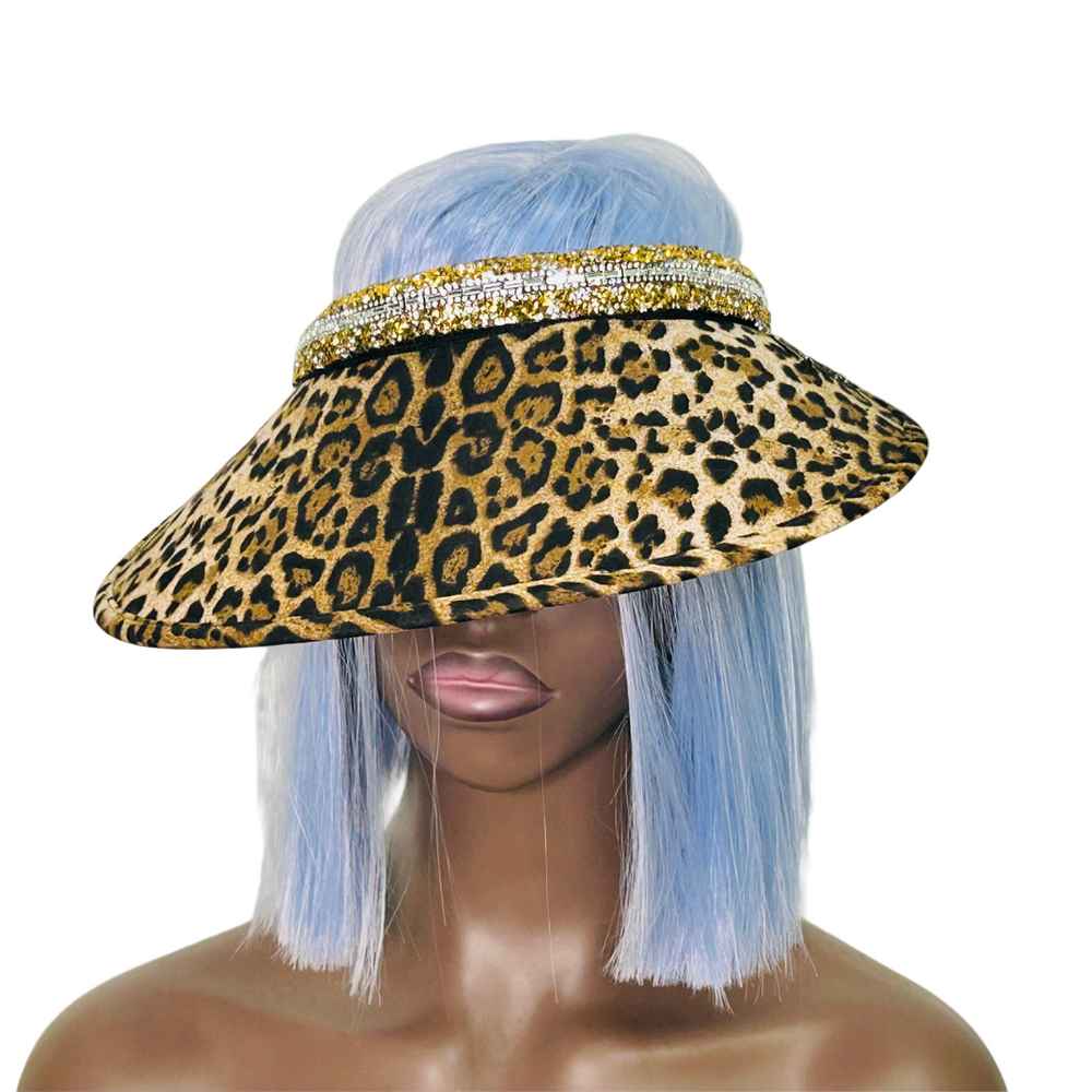 Leopard print visor hat with decorative band on a mannequin head against a gray background
