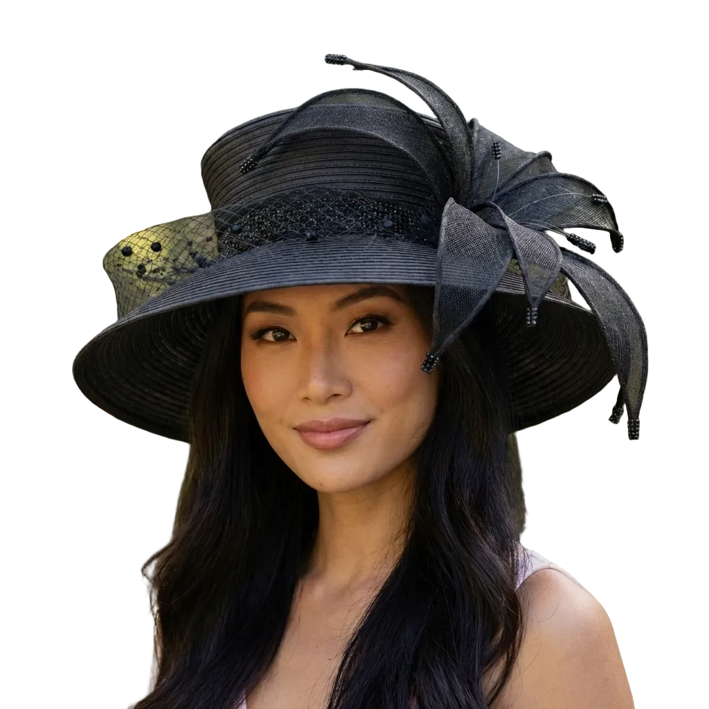 Woman wearing a black decorative hat with a blurred green background