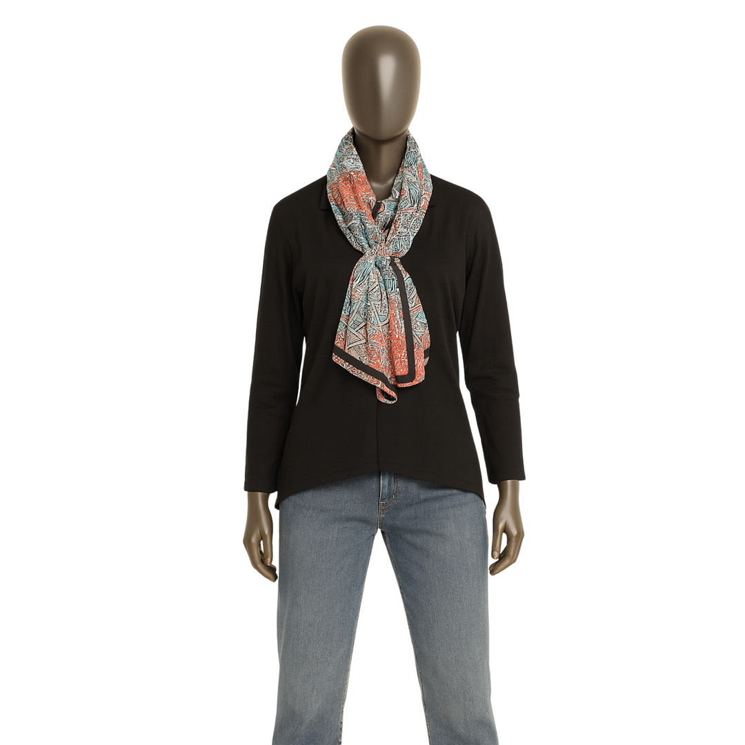 Mannequin wearing a black top, patterned scarf, and jeans on a white background