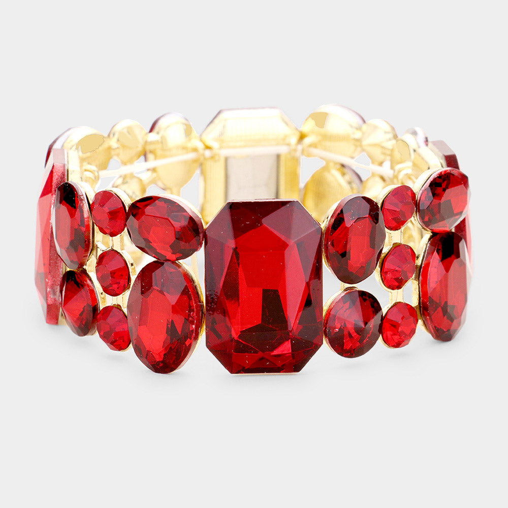 Bracelet with red gemstones and gold accents on a light gray background